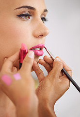 Image showing Woman, lipstick and makeup artist for beauty application for professional treatment or cosmetic, product or brush. Female person, fingers and tool for mouth preparation or skincare, beautician or job