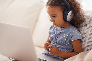 Image showing Kindergarten, kid and elearning on laptop in home with online class, video and girl with headphones. Virtual, education and child with computer on sofa in house for development of language knowledge