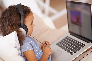 Image showing Elearning, video and kid on laptop in home with online class, website and girl with headphones. Virtual, education and child streaming course on sofa in house for development of language knowledge