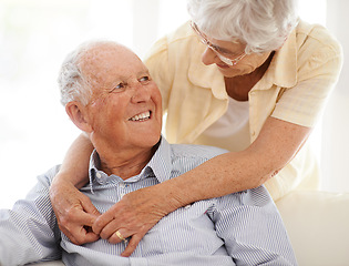 Image showing Couple, senior and hug or love in looking, home and relax together for bonding and smile. Elderly people, embrace and care in marriage or relationship in retirement, couch and security in house