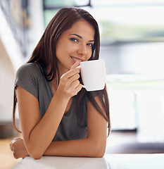 Image showing Portrait, coffee and happy with woman in kitchen of home to relax in morning or on weekend time off. Smile, relax and mug with face of young person drinking tea in apartment for peace or wellness