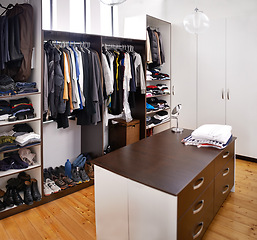 Image showing Closet, home and clothes with interior design apartment luxury for walk in wardrobe, empty room or hanging. Storage, drawers and fashion organization in house or dressing room, furniture or shelves