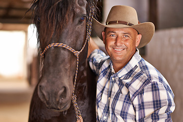 Image showing Cowboy, man and horse in stable with smile in portrait for care, growth or development at farm, ranch or countryside. Person, animal or equine pet with love, happy or connection for wellness in Texas