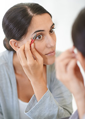 Image showing Face, cosmetics and tweezer with eyebrows of woman in mirror of home bathroom for grooming or hygiene. Beauty, cleaning or wellness with young person in apartment for morning hair removal routine