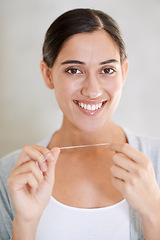 Image showing Woman, portrait and smile with dental floss in home for health, wellness or care for teeth in morning. Girl, person and happy with string for oral, mouth or cleaning for hygiene at apartment in Chile
