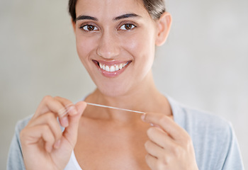 Image showing Woman, portrait and happy with dental floss in home for health, wellness or care for teeth in morning. Girl, person and smile with string for oral, mouth or cleaning for hygiene at apartment in Chile