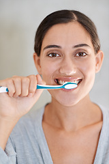 Image showing Woman, portrait and brushing teeth with smile in home for health, wellness or care for breath in morning. Girl, person and happy with toothbrush, mouth and cleaning for hygiene at apartment in Chile