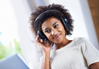 Image showing Face, music on laptop and smile with black woman in living room of home for relax or radio streaming. Computer, headphones and internet with happy young person in apartment for social media browsing