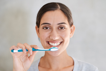 Image showing Woman, portrait and happy for brushing teeth in home for health, wellness or care for breath in morning. Girl, person and smile with toothbrush, mouth and cleaning for hygiene at apartment in Chile