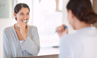 Image showing Woman, brushing teeth and happy in home by mirror for health, wellness or self care for breath in morning. Girl, person and smile with toothbrush, mouth and cleaning for hygiene at apartment in Chile