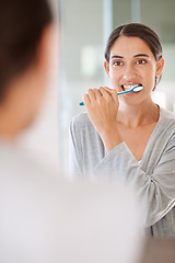 Image showing Woman, brushing teeth and smile in home by mirror for health, wellness or self care for breath in morning. Girl, person and happy with toothbrush, mouth and cleaning for hygiene at apartment in Chile