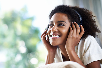 Image showing Woman, smile and headphone on head for podcast, music and audio indoor with bokeh background and mockup. Young person or student with technology or gadget for carefree and weekend with radio and song