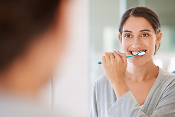 Image showing Woman, brushing teeth and smile in morning by mirror for health, wellness or self care for breath in home. Girl, person and happy with toothbrush, mouth and cleaning for hygiene at apartment in Chile