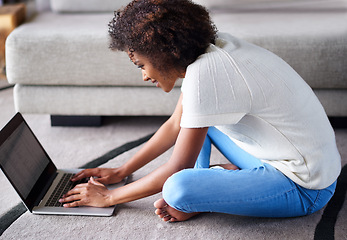 Image showing Happy, laptop and portrait of woman on floor working on freelance creative project in living room. Smile, technology and African female designer typing on computer for research on rug in apartment.