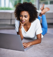 Image showing Reading, laptop and woman on carpet working on freelance creative project in living room. Relax, technology and young female designer typing on computer for research on floor in modern apartment.