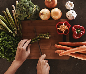 Image showing Person, hands and knife with vegetables, chopping board and food with ingredients and wellness. Closeup, utensils and chef with salad and lunch with diet plan and healthy meal with dinner and home