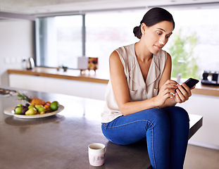 Image showing Woman, kitchen counter and smartphone to browse social media for information, news update or entertainment. Female person, home and searching internet for online blog, mobile app and website.