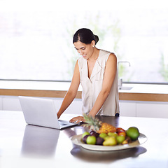 Image showing Woman, kitchen and browse website on laptop for recipe ideas or nutritional information for meal planning. Female person, computer and online or search for digital cookbook and food menu for dinner.