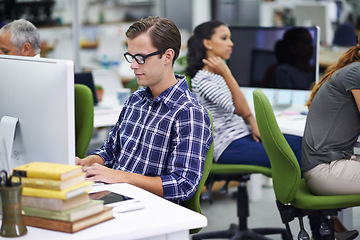 Image showing Man, working and desk with coworkers on computer in office, digital design for online research for business website. Colleague, career and employees for creative company, typing or browse on internet