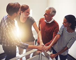 Image showing Lens flare, group of people or hand for unity, diversity or hope to trust, synergy or collaboration. Team, smile and huddle to support, gender equality and inclusion for cooperation and solidarity