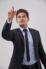 Image showing Future, innovation and pointing with businessman user in studio on white background for metaverse access. Corporate, digital transformation and network interface with young employee in suit at work