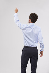 Image showing Pointing, mockup and back of businessman in studio for direction hand gesture with marketing space. Career, mock up and behind of professional male employee with presentation by gray background.