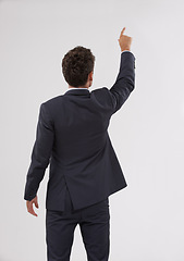 Image showing Pointing, mockup and behind of businessman in studio for direction hand gesture with marketing space. Career, mock up and back of professional male employee with presentation by gray background.