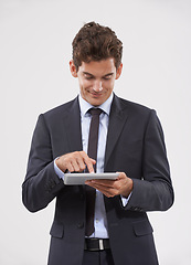 Image showing Business, typing and man holding a tablet, communication or connection on white studio background. Web, person or model with tech, internet and social media with email notification and digital app