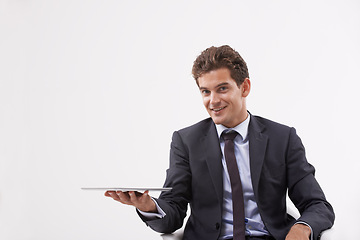 Image showing Portrait, presentation and man holding a tablet, communication or digital app on white studio background. Face, person or model with technology, internet or social media with email, showing and smile