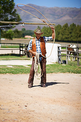 Image showing Cowboy, ranch and lasso in boots, sun and straps for wrangler and Texas farmer at stable. Mature man, wild west and summer in agriculture, hat and male person with rope in farm job and environment