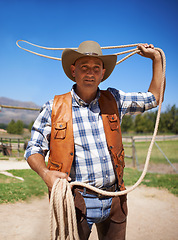 Image showing Cowboy, ranch and lasso in outdoor, sun and straps for wrangler and Texas farmer at stable. Mature man, wild west and summer in agriculture, hat and male person with rope in farm job and environment