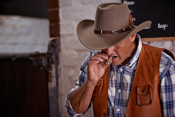 Image showing Smoking, cigar and senior cowboy on ranch for farming, agriculture and stable for rodeo animals. Western, countryside and mature farmer, man and rancher with cigarette, tobacco and smoke in Texas