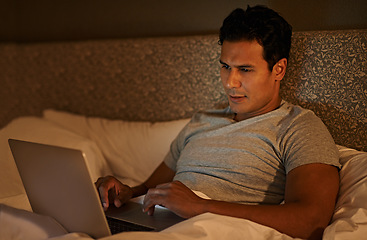 Image showing Man, happy and laptop in bedroom at night, online subscription and streaming movie to watch on weekend. Calm person, relax and computer on bed in duvet, wellness and scroll on social media in home