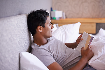 Image showing Man, rest and reading a book in bedroom, calm and adventure in action novel on break in morning. Person, learning and inspiration in self help manual, creativity and relax in warm blanket on vacation