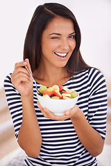 Image showing Fruit, portrait and wink with healthy eating woman, bowl and happy for fresh food. Natural, nutrition and sustainable for vegetarian, fiber and breakfast or dessert for minerals and vitamins