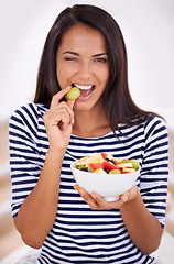 Image showing Fruit, portrait and wink for healthy eating, bowl and wink with fresh food. Natural, nutrition or sustainable for vegetarian, fiber and breakfast or dessert for minerals and vitamins with grape