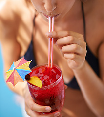 Image showing Vacation, hand and woman drinking cocktail in bikini for travel, weekend break and summer party in Fort Lauderdale. Person, glass and alcohol in swimwear for relax, peace and rest at holiday resort