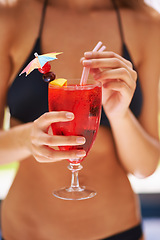 Image showing Cocktail, hand and woman in bikini on vacation, weekend break and summer party in Fort Lauderdale. Person, glass and alcoholic drink in swimwear for relax, peace and rest outdoor at holiday resort
