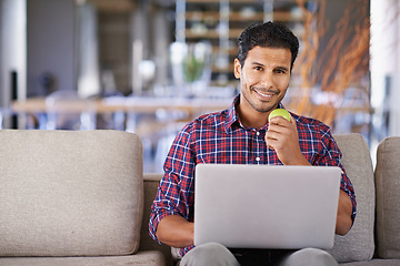 Image showing Businessman, portrait and laptop with apple working, busy and smile on couch or sofa. Freelancer, career and male person in lounge with computer for technology and connectivity at home or living room