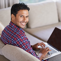 Image showing Businessman, portrait and laptop on sofa or living room, working and busy in couch. Freelancer, career and male person in lounge with computer for typing, technology and connectivity at home or house