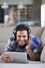 Image showing Man, headphones and tablet for music or website, home and internet for streaming. Happy male person, relax and song app on couch for audio or podcast, smile and online for blog or subscription