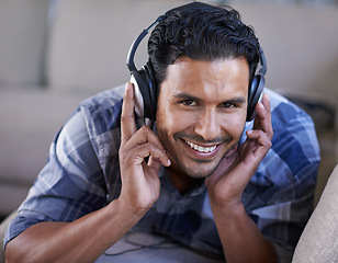 Image showing Man, headphones and portrait for song on couch, relax and streaming radio for music or sound. Happy male person, home and lying on sofa for peace, comfortable and hearing jazz playlist on weekend