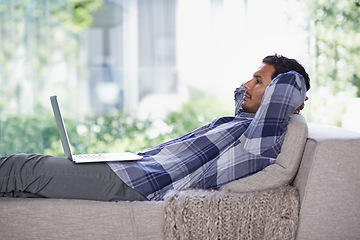 Image showing Man, laptop and living room with home, rest and internet for relax and streaming. Indian person, web and tech with house, lounge or apartment for watching video and connectivity with subscription