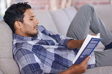 Image showing Man, relax and couch with book for reading for information or knowledge, development and quiet time for comfort. Male person, leisure and literature novel for learning or contentment and inspiration.