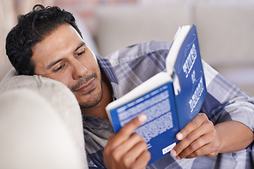 Image showing Man, couch and reading a book for knowledge in home, literature and information. Happy male person, story and fiction novel for education in living room on weekend, comfortable and relax on sofa