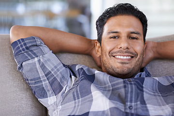 Image showing Man, portrait and couch to relax in living room, smile and satisfaction with lying on weekend. Happy male person, lounge and calm or comfortable in apartment, closeup and confident for peace and sofa