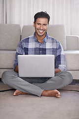 Image showing Man, internet and portrait for laptop on floor of living room, education and scroll or browse on website. Male person, student and online for info or home for app, sitting and elearning or study