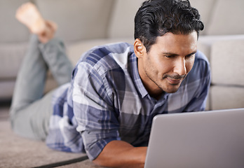 Image showing Man, freelancer and internet for laptop on floor of living room, research and scroll or browse on website. Male person, happy and online for information or home for app, remote work and plan on tech