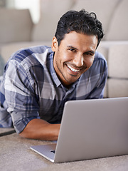 Image showing Man, freelancer and internet for laptop in portrait of living room, research and scroll or browse on website. Happy male person, floor and online for information or home for app, remote work and plan