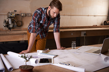 Image showing Man, review blueprint and architect with engineering or construction, renovation project and design for building. Floor plan, sketch and property development with assessment of paperwork in workshop